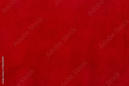 Red suede texture. Natural red dyed leather, suede macro photo.