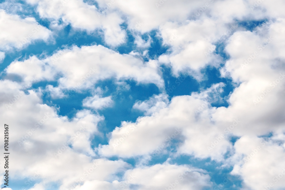 Obraz premium White cumulus clouds on a blue sky.