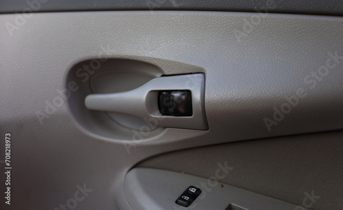 Close-up of a sleek car door handle, embodying modern design and luxury, with reflections hinting at adventure and elegance