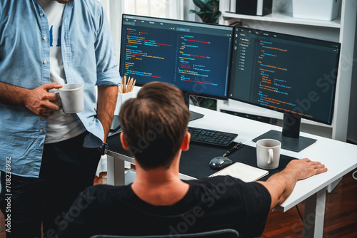 Obraz na płótnie IT developers discussing online software development information on pc screen, creating program coding for latest version application on website. Concept of brainstorming firmware updated. Sellable.
