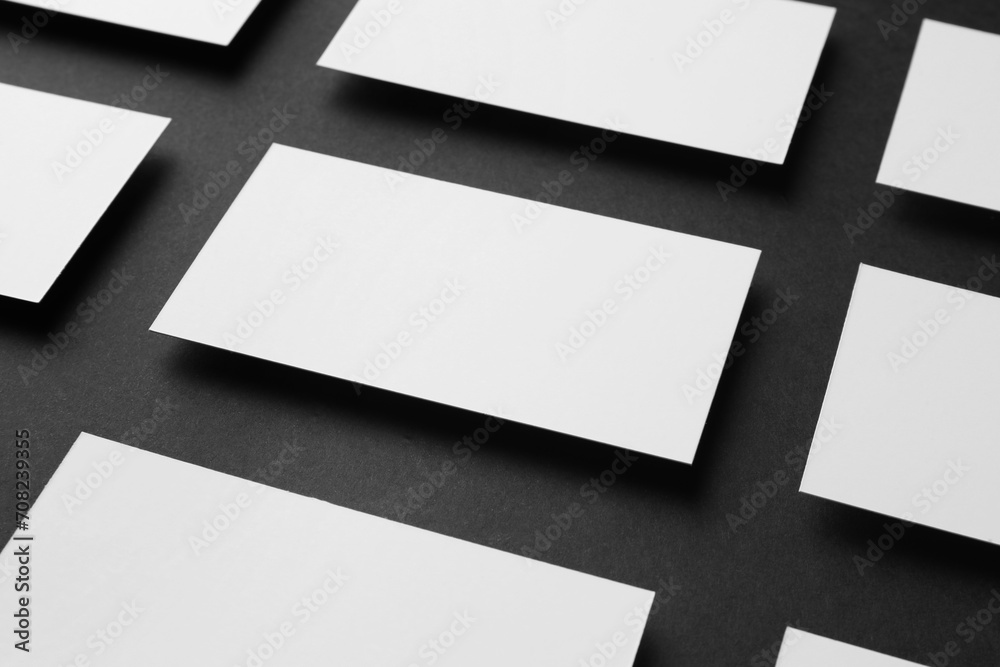 Obraz premium Blank business cards on black background, closeup. Mockup for design