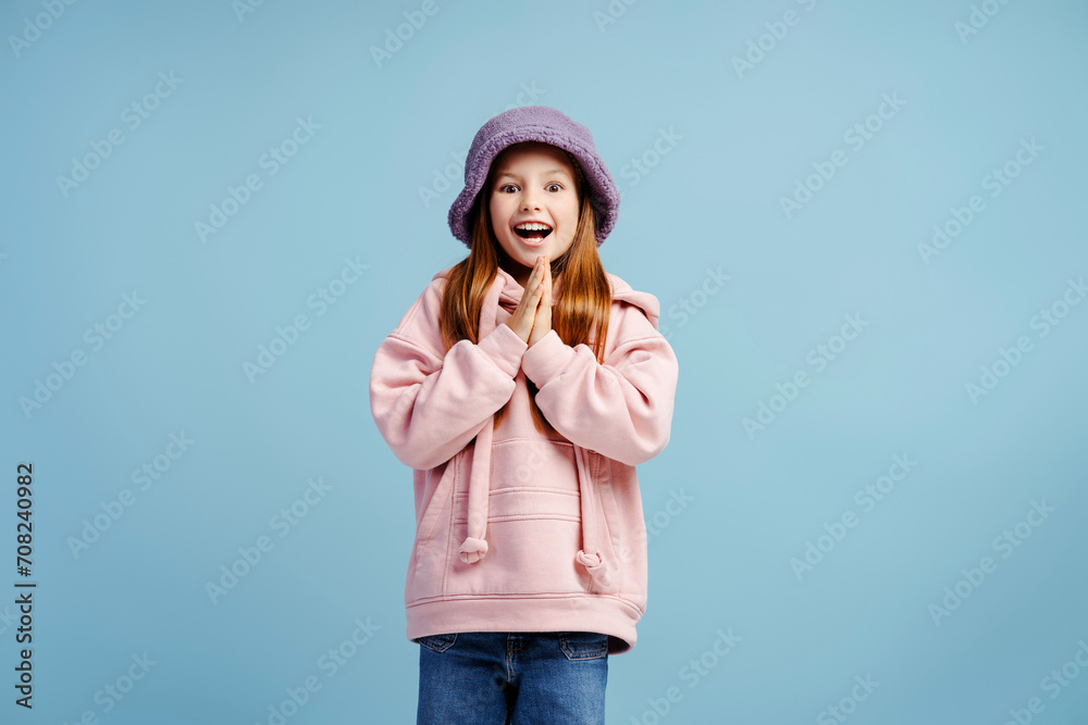 Portrait of excited little girl wearing casual clothes with open mouth looking at camera Portrait of excited little girl wearing casual clothes with open mouth looking at camera