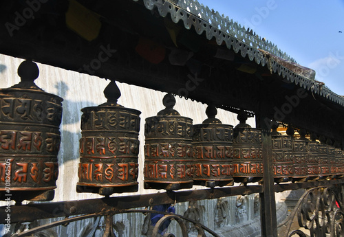 Spinning bronze prayer wheels at Swayambhunath temple.