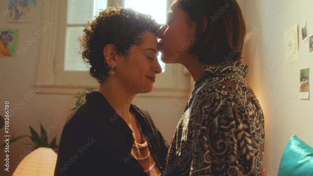 Young affectionate lesbian girls rubbing noses and kissing each other