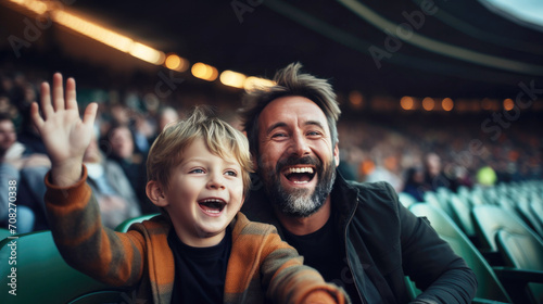 father and son cheer football team at grandstand..cheer for their favorite team at a sports match, football, competition, stadium, arena photo