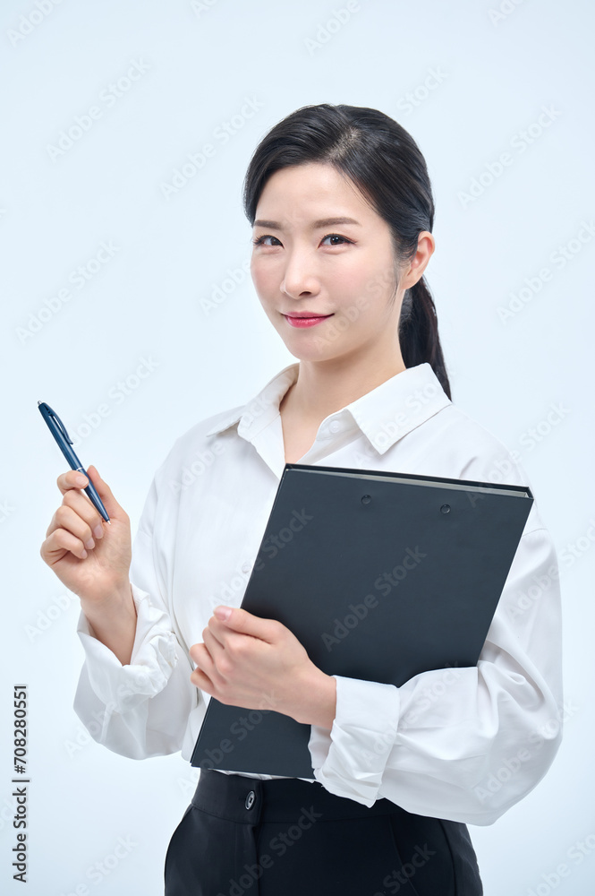 A beautiful Asian woman is making various facial expressions and gestures while holding a document file and a ballpoint pen for business. A beautiful Asian woman is making various facial expressions and gestures while holding a document file and a ballpoint pen for business.