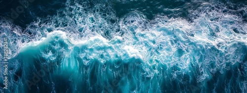 beautiful photo of blue water flowing in waves with white foam in a ocean. taken from up top above perspective. very wide banner wallpaper background 8:3