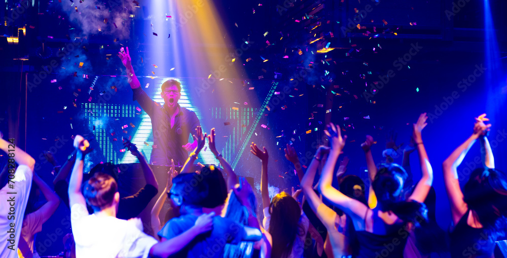 DJ with Turntables at nightclub. Group of diverse young people dancing ...