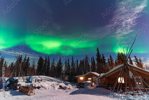 Aurora Borealis, Northern Lights, over aboriginal wooden cabin at Yellowknife, Northwest Territories, Canada