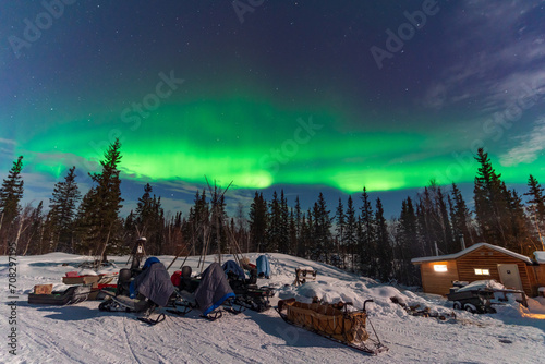 Aurora Borealis, Northern Lights, over aboriginal wooden cabin at Yellowknife, Northwest Territories, Canada