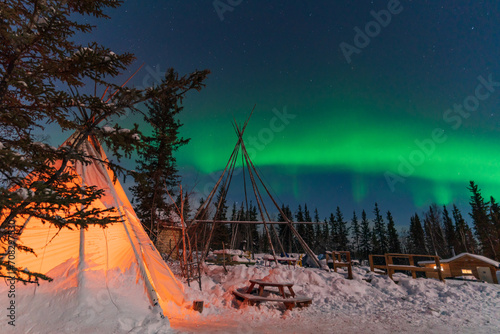 Aurora Borealis, Northern Lights, over aboriginal tent teepee at Yellowknife, Northwest Territories, Canada