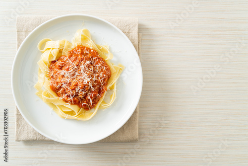 pork bolognese fettuccine pasta with parmesan cheese