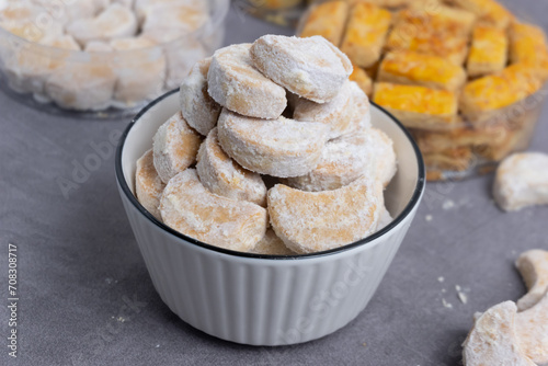 Kue Putri Salju are cute crescent shaped vanilla cookies with a crumbly, and covered in confectioners sugar. Indonesian dry cakes, for the celebration of Eid al-Fitr photo