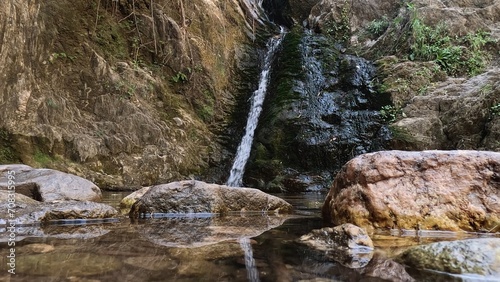 River with a waterfall and a rock wall