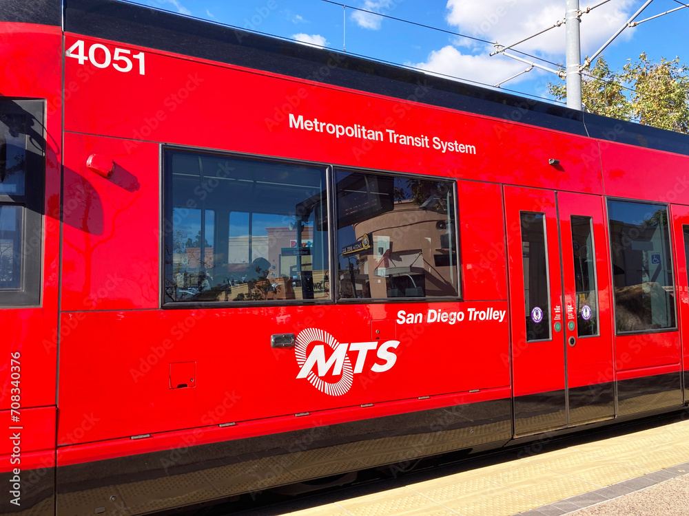 Side view of San Diego Trolley Siemens S70 train stopped at station