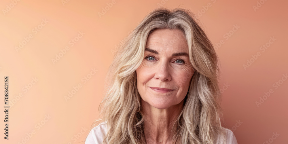 Close up of a confident middle aged woman with a peach copyspace background Close up of a confident middle aged woman with a peach copyspace background