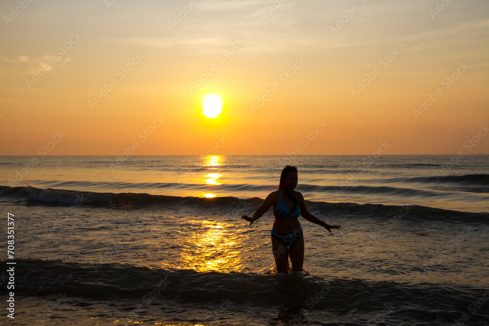 Woman body big with bikini and sunrise on beach