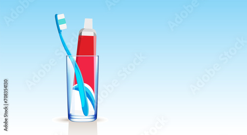 Set of a blue toothbrush and toothpaste in a medical tube in a glass beaker on a blue gradient background. Copy space.