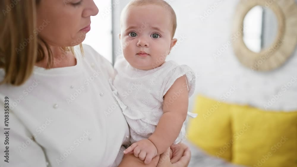 Mother standing in bedroom, arms lovingly hugging her daughter; a picture of relaxed family love Mother standing in bedroom, arms lovingly hugging her daughter; a picture of relaxed family love