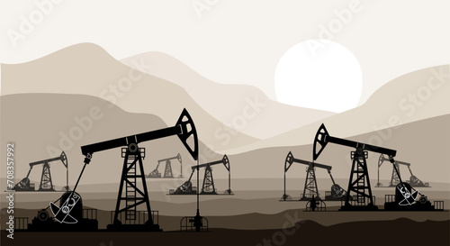 Oil pumps and drilling rigs at the field during sunset.