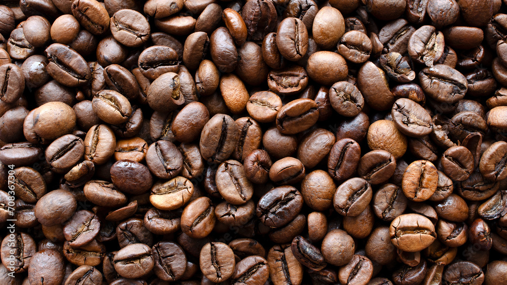 Obraz premium Roasted coffee background, texture, top view. Top view of coffee beans, background, texture. Coffee beans as a background for packaging use.