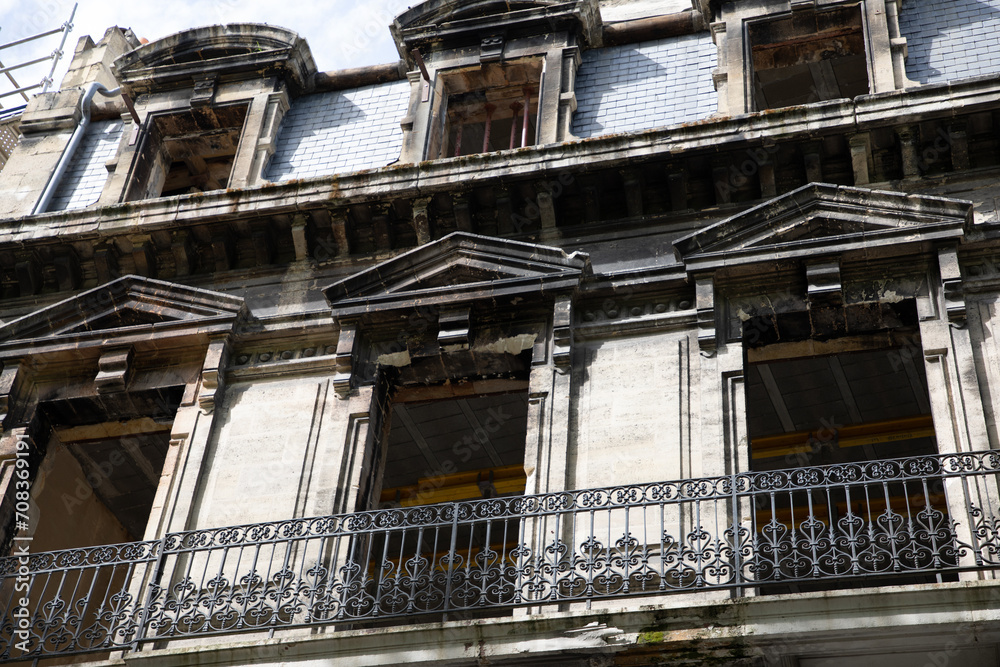 old facade with balcony of a building undergoing interior and exterior restoration