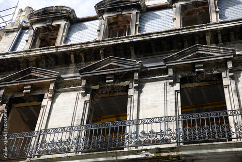 old facade with balcony of a building undergoing interior and exterior restoration © OceanProd