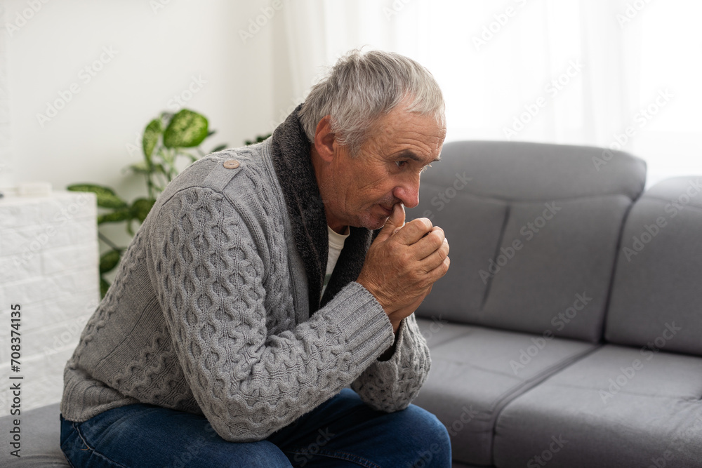 Portrait praying senior man against white background