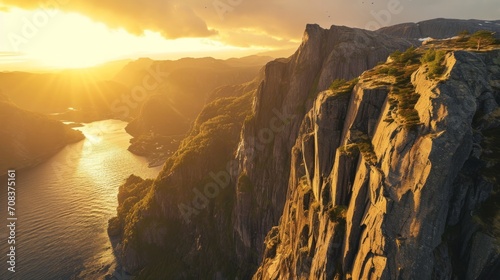 conic fjord landscapes, drone's perspective, golden hour tones, rugged cliffs, photorealistic sunset over Norwegian fjords Generative AI © vadosloginov