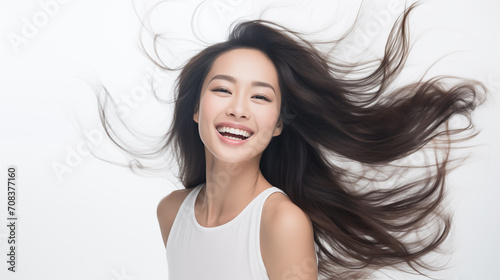 Wallpaper Mural A joyous East Asian woman with her hair flowing freely in the air, capturing a moment of carefree bliss. Torontodigital.ca