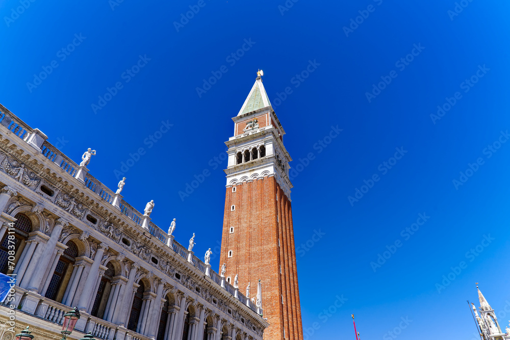 Old town of Italian City of Venice with famous Campanile of cathedral at Piazza San Marco square on a sunny summer day. Photo taken August 7th, 2023, Venice, Italy.