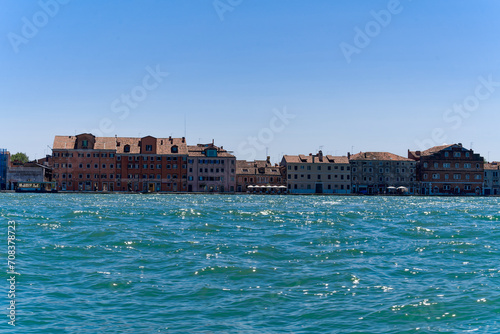 Scenic view of San Giorgio Canal with skyline of Giudecca in the background at Italian City of Venice on a sunny summer day. Photo taken August 7th, 2023, Venice, Italy.