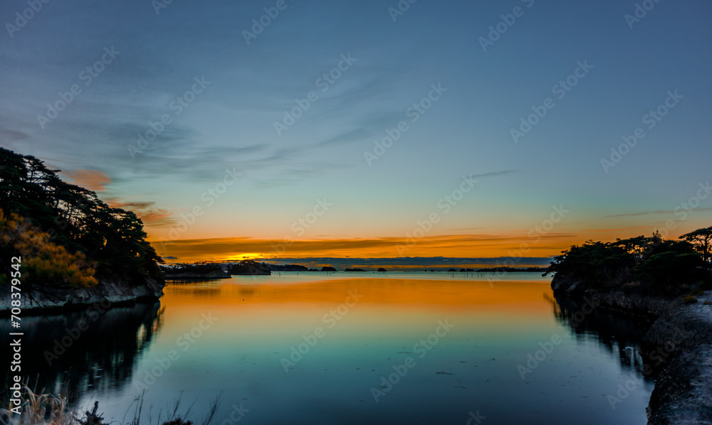 Fototapeta premium Sunrise over the ocean with reflection on the water