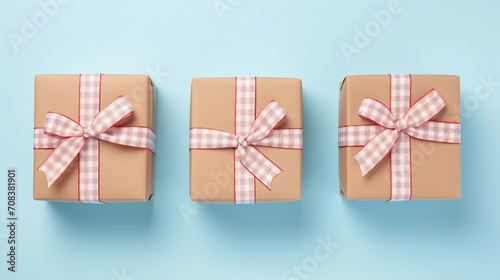 Captivating St. Valentine's Day Scene: Woman's Hands Tying Checkered Ribbon Bow on Craft Paper Giftbox, Top View on Pastel Blue Background