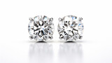 beautiful white diamond stud earrings with reflection on a white background
