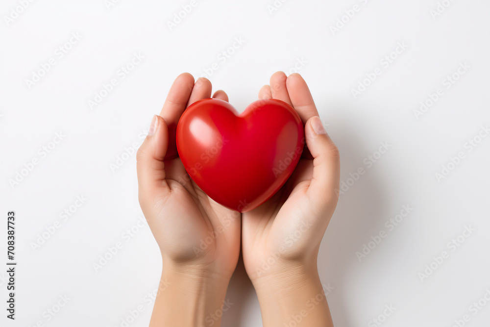 hands hold a red heart on a white background hands hold a red heart on a white background