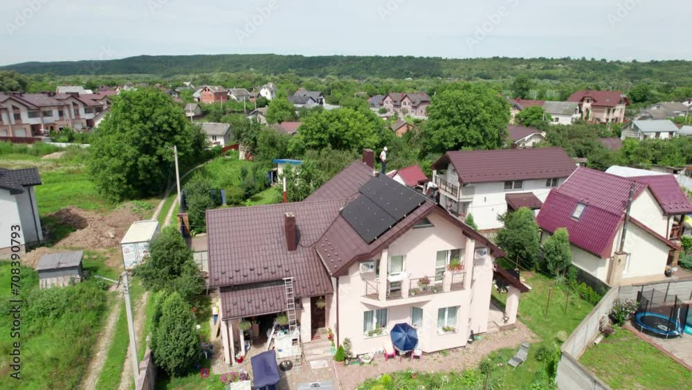 House with solar panels on rooftop for generating electricity through photovoltaic effect. Home with solar power system on roof. Concept of alternative energy, autonomy, power sustainable resources. House with solar panels on rooftop for generating electricity through photovoltaic effect. Home with solar power system on roof. Concept of alternative energy, autonomy, power sustainable resources.