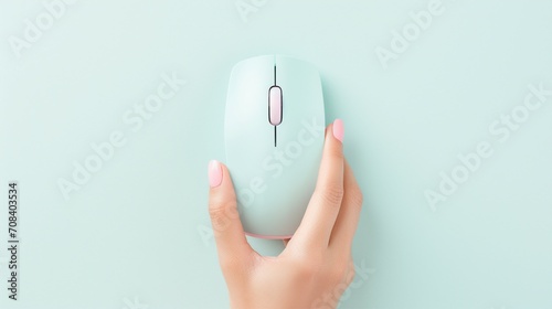 Top view of a hand using a wireless computer mouse for searching necessary information on an isolated pastel color background with copy-space for text or promotional content. photo
