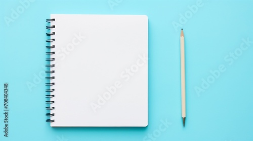 Simplicity Redefined: Top View Flat Lay with Blank Notebook and Pencil on Pastel Blue Background, Ideal for Minimalistic, Trendy, and Creative Designs.