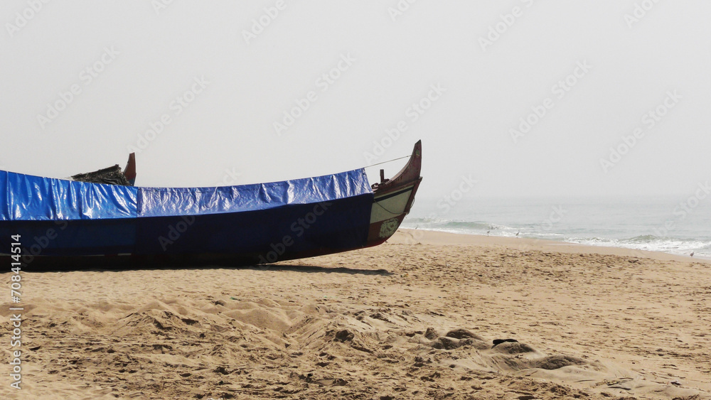 Fishing boat moored on the beach at Adimalathura, Thiruvananthapuram, Kerala, India