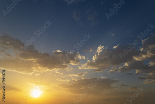 Beautiful blue sky with white clouds lit by the sun.