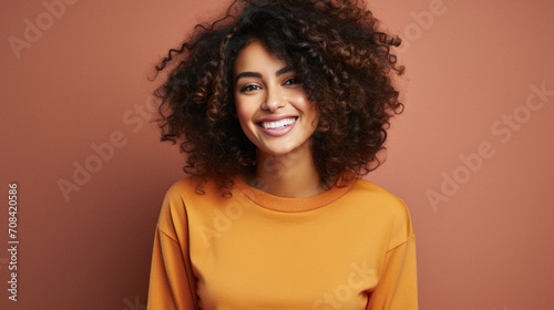 Beautiful african american woman in yellow sweater smiling at camera