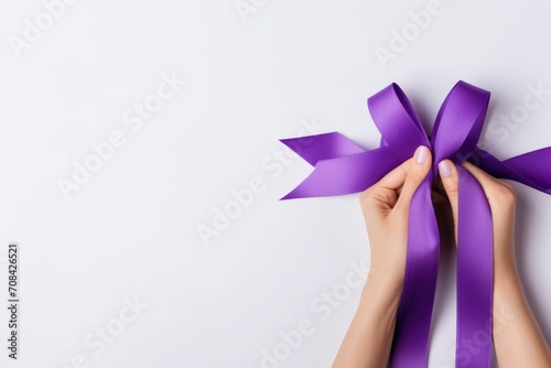 Hands holding purple or violet ribbon with copy space. Pancreatic Cancer, Cancer Survivor, Testicular Cancer Awareness, Leiomyosarcoma, World Cancer Day. Healthcare concept. photo