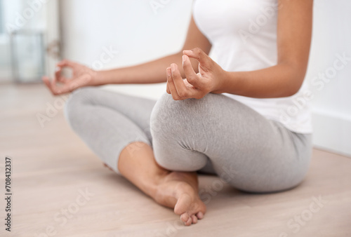 Woman hands, meditation and spiritual in a home with mockup space and chakra for balance and mindfulness. Morning, wellness and zen in house on floor to relax for calm and peace in lotus position