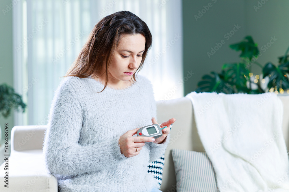 Young woman measures blood sugar level Young woman measures blood sugar level