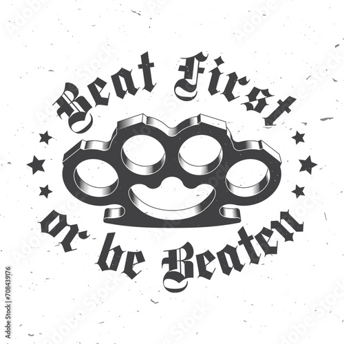 Beat first or be beaten. Classic gangster badge design. Vector illustration. Vintage monochrome label, sticker, patch with knuckle duster silhouette.