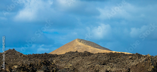 Spectacular view of the Fire Mountains at Timanfaya National Park, this unique area consisting entirely of volcanic soils. Volcanic landscape in a sea of ​​lava. Plenty space of text. Lanzarote, Spain