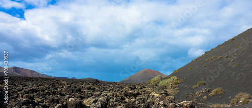 Spectacular view of the Fire Mountains at Timanfaya National Park, this unique area consisting entirely of volcanic soils. Volcanic landscape in a sea of ​​lava. Plenty space of text. Lanzarote, Spain