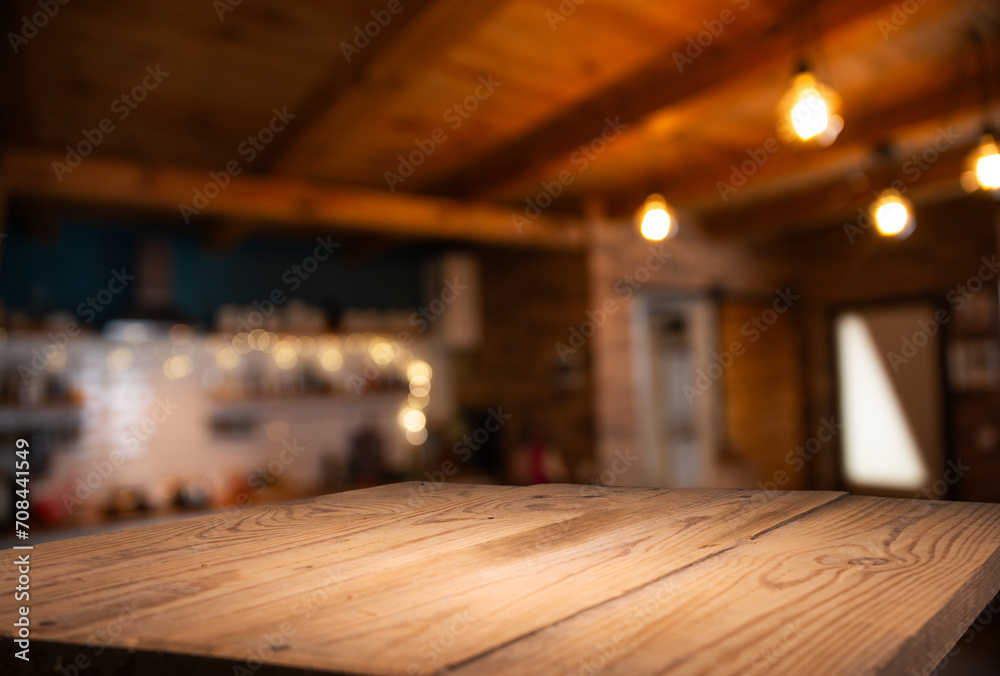 Wooden table of free space in kitchen and blurred vegetables . High quality photo