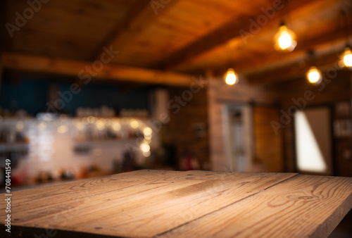 Wooden table of free space in kitchen and blurred vegetables . High quality photo